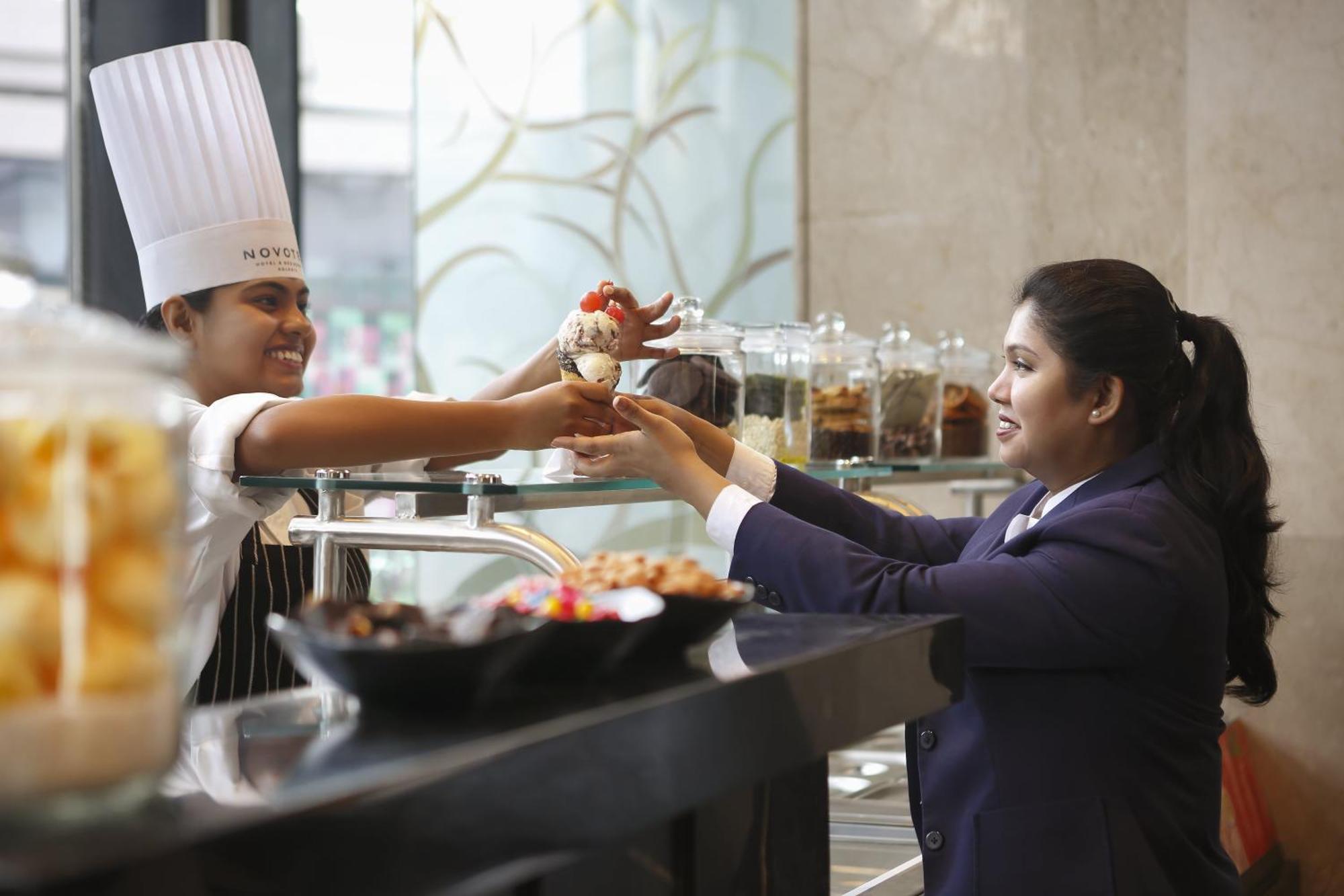 Novotel Kolkata Hotel And Residences Экстерьер фото A chef serving food to a guest